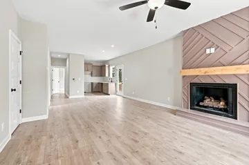 Open living room with a fireplace and a panelled feature wall