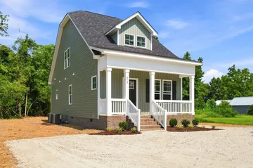 The front porch and side elevation of the completed home